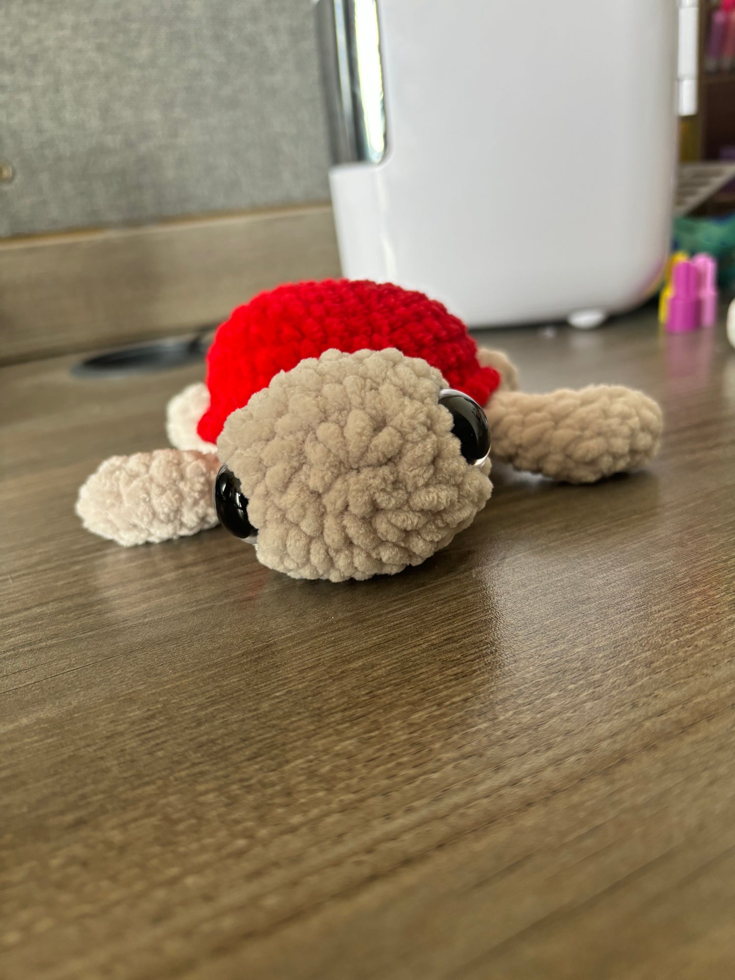 Champagne and red crochet turtle