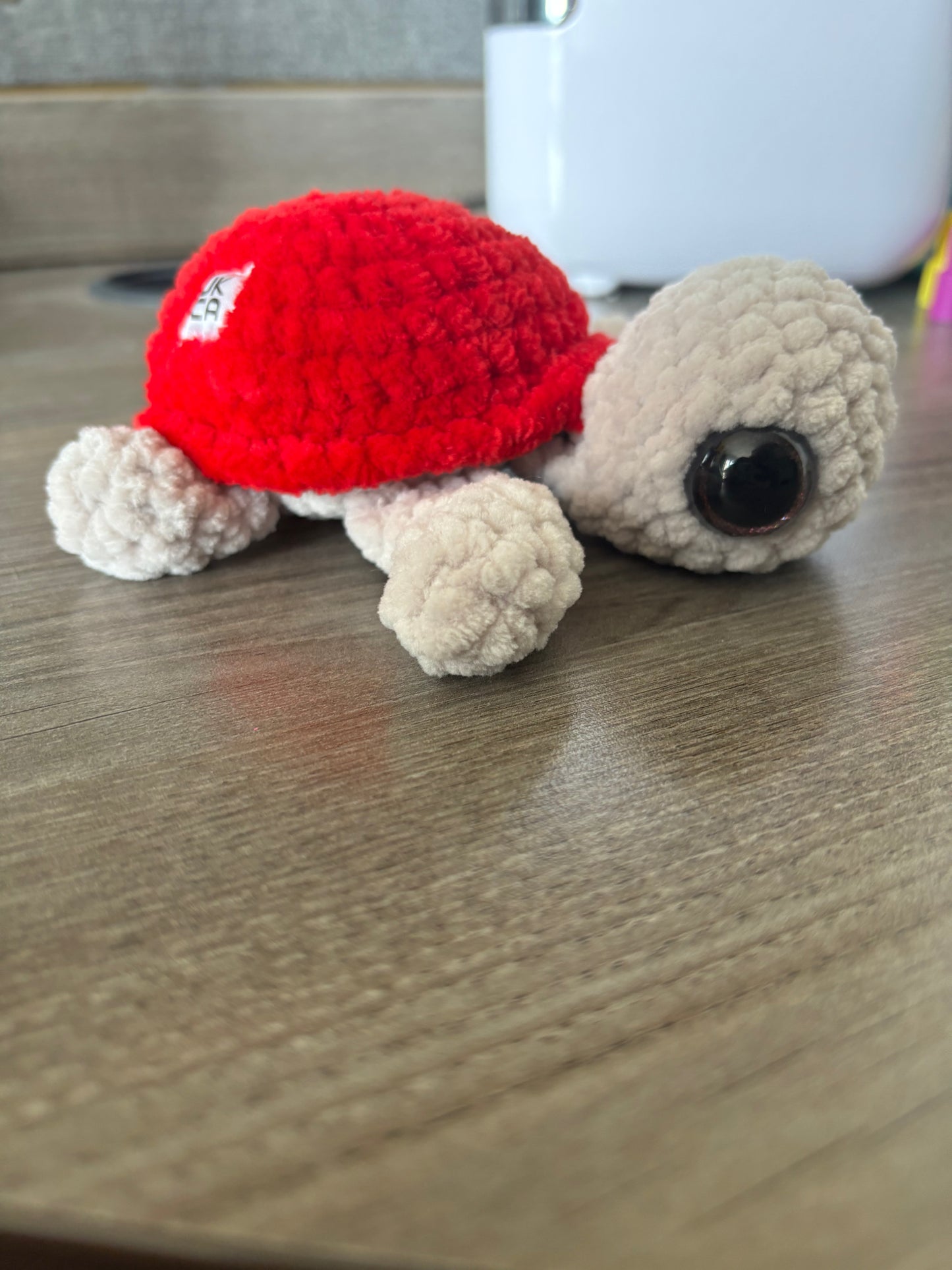 Champagne and red crochet turtle